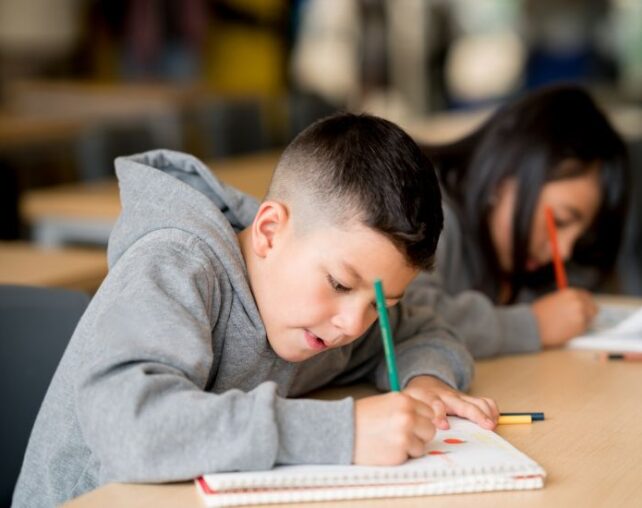 student in class writing