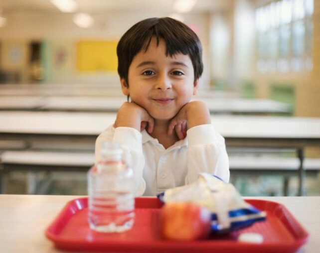 Young boy with tray of food